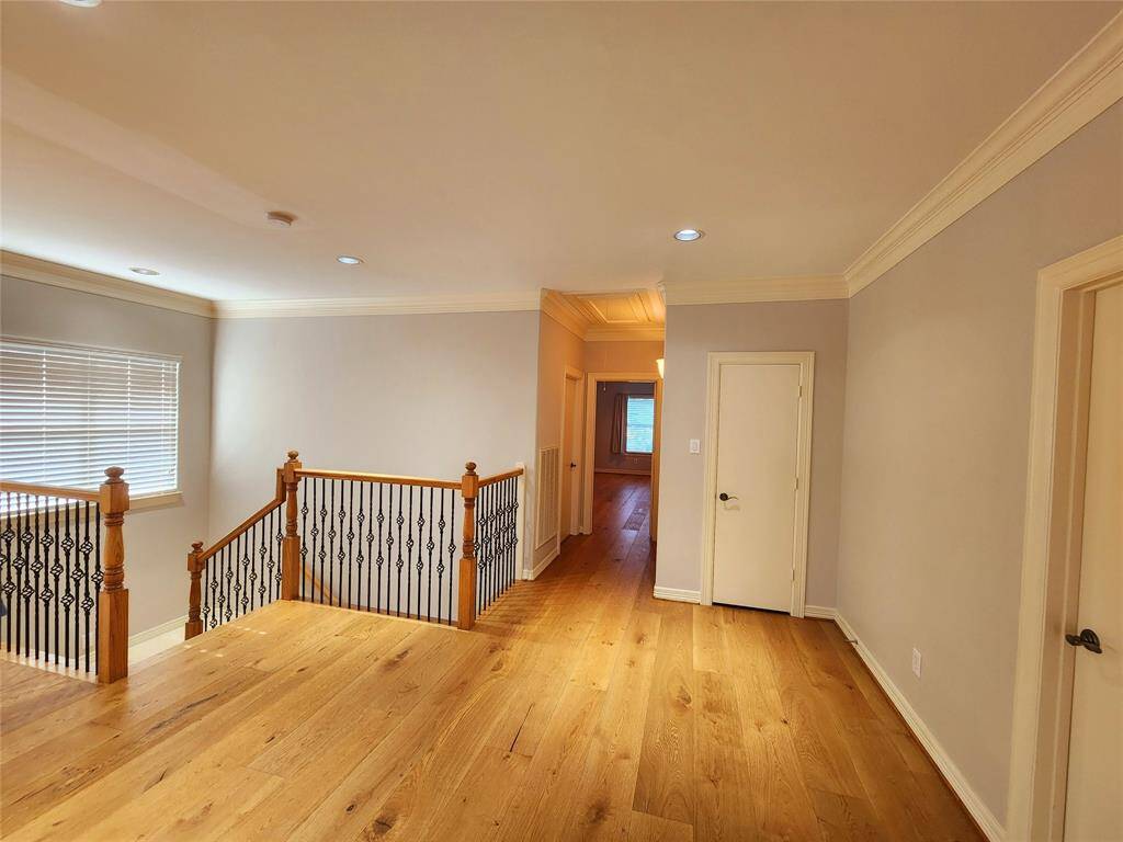Just past the stairs is the small hallway to the laundry room and primary suite.