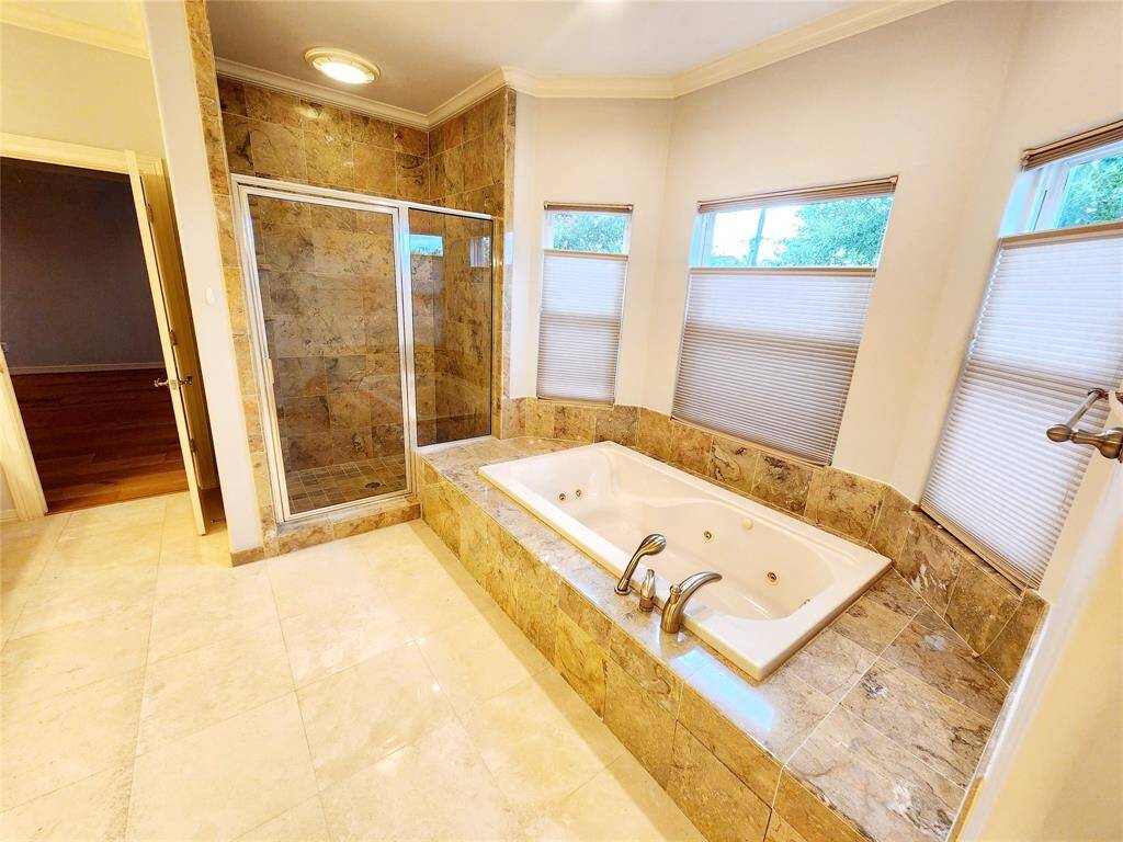 View of shower and bath in Primary Bathroom.