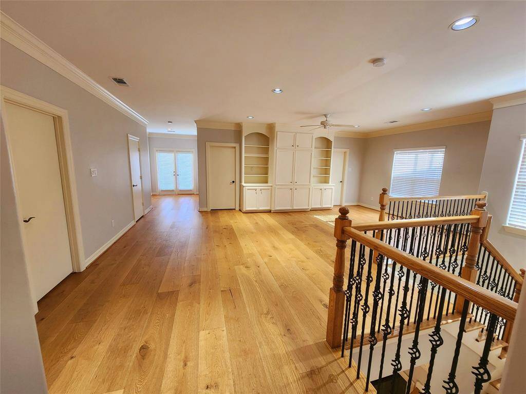 View of the second floor landing area, game room and study area overlooking the exterior balcony.