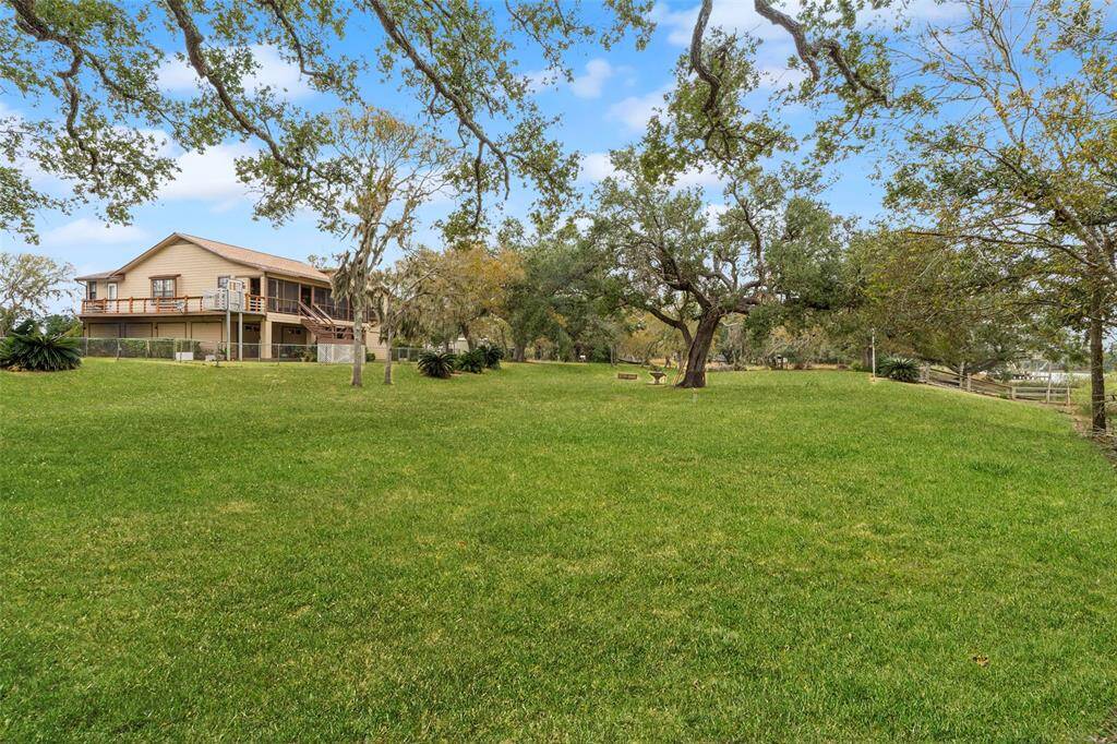 The expansive green space offers ample room for outdoor activities, while the upper deck provides a relaxing view of the peaceful surroundings.