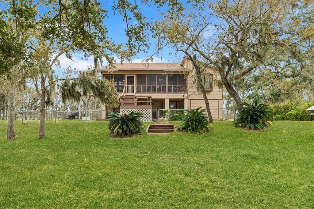 This charming two-story home is situated on over 2.5 acres and features lush front yard and mature trees. The house features a screened-in balcony, perfect for enjoying the peaceful surroundings.