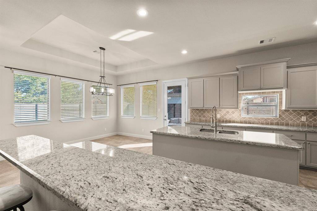 Kitchen and dining with windows and door to patio