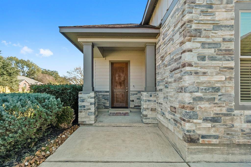 Entrance with architectural detail and wood door