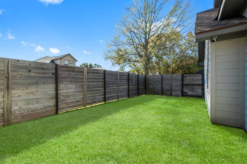 Lush backyard perfect for lawn games