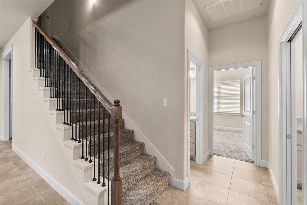 Beautiful staircase and hall to bath, utility and secondary bedroom