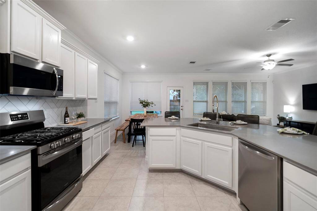 A beautiful quartz kitchen complete with breakfast bar with built-in sink—perfect for both meal prep and casual gatherings.