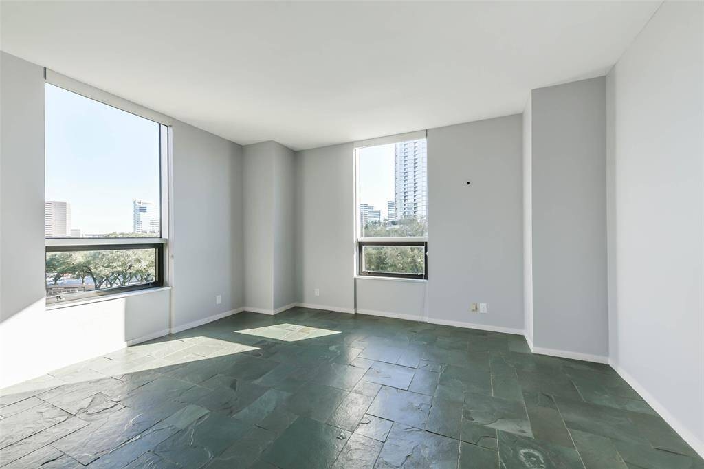 The primary bedroom offers views of Uptown and the Galleria.