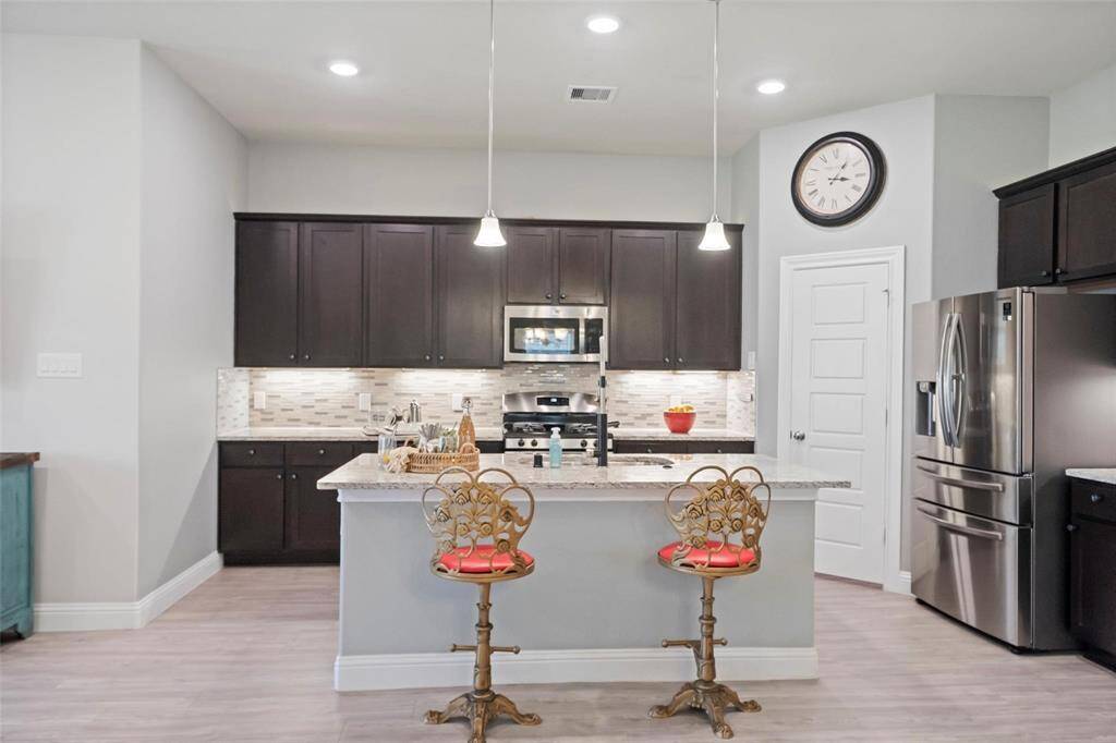 The kitchen has been freshly painted and has a large pantry.