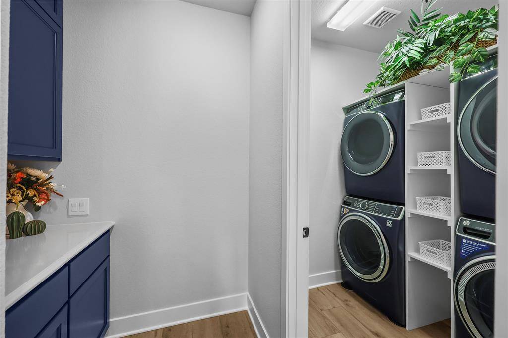 Additional cabinetry and countertop space can be found at the butler's pantry. The laundry room is equipped with 2 sets of washer/dryer connections, which grants time efficiency for everyone's favorite chore! There is custom shelving to help facilitate organization & functionality into this space.