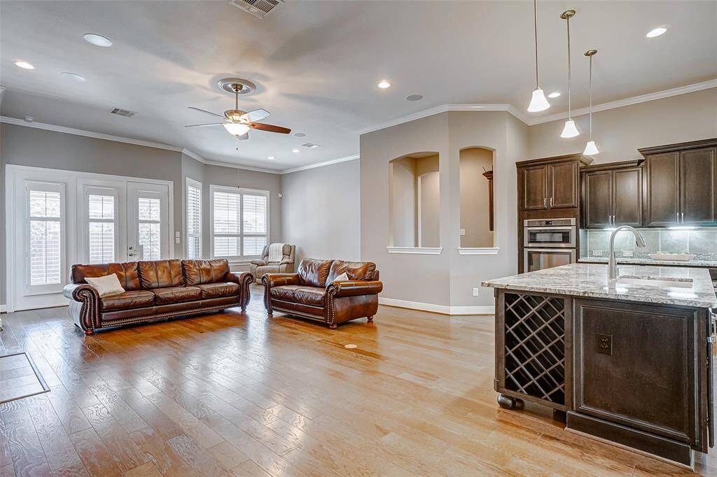 The open floor plan has many upgrades including wood floors and plantation shutters.