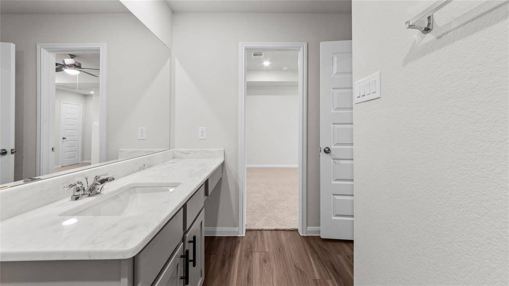 Elegant master bathroom with sleek finishes, spacious vanity, and modern fixtures.