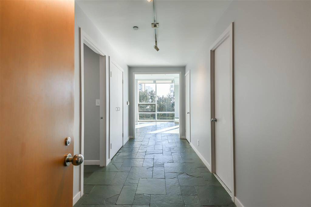The entry to the unit shows additional closets for storage.