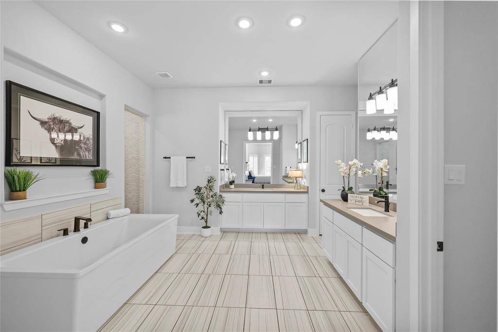 Through french doors you'll find the luxurious primary bathroom retreat. It provides the space & finishes of a daily spa-like experience.