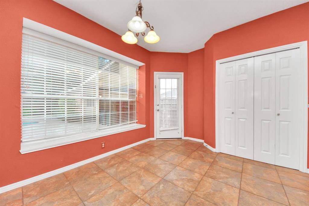 The breakfast room has access to the covered walk way that leads to the 3-car garage.