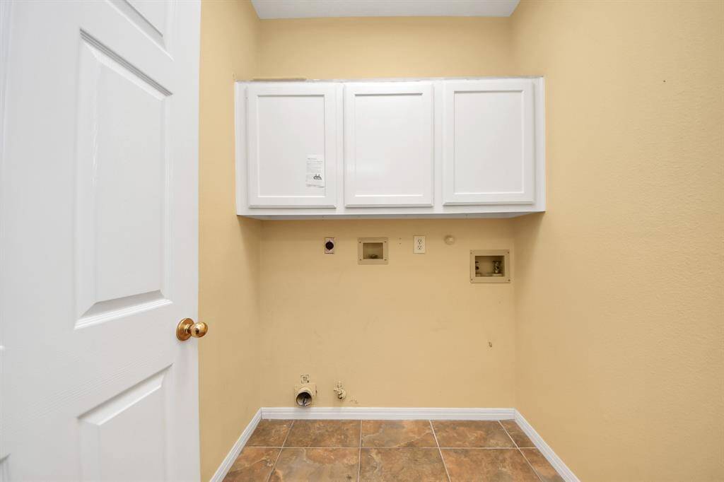 The laundry room features both electric and gas - also has added storage.