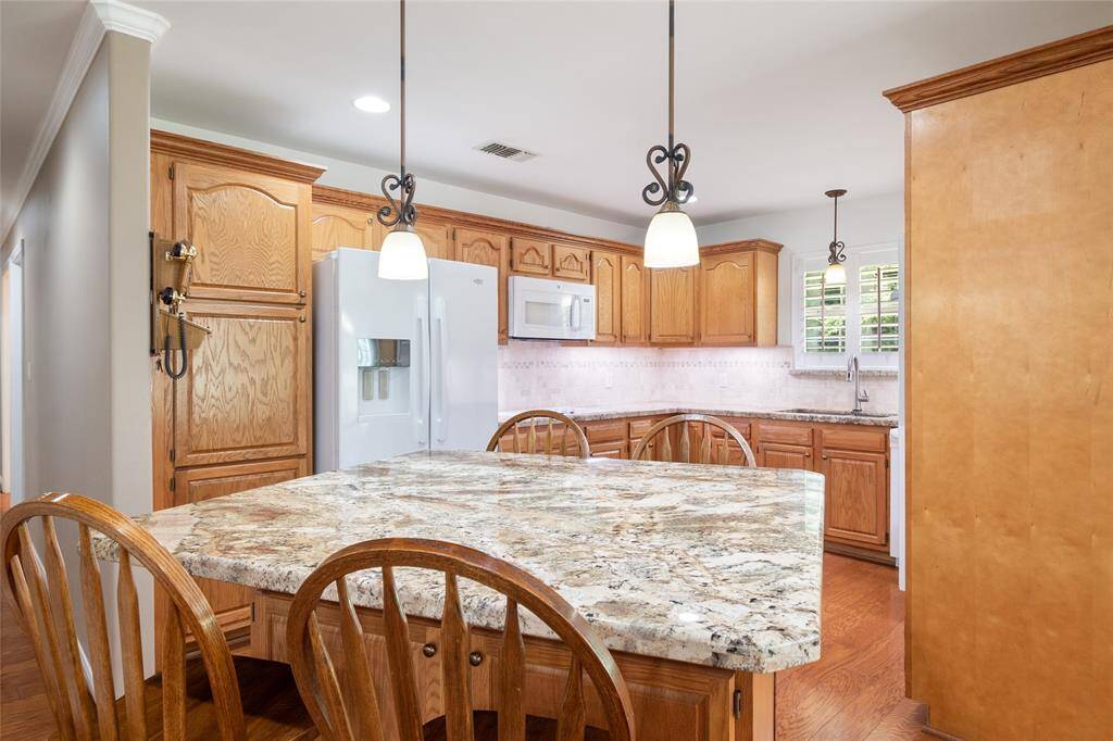 Amazing custom built Granite island with room for extra seating and cabinet storage.