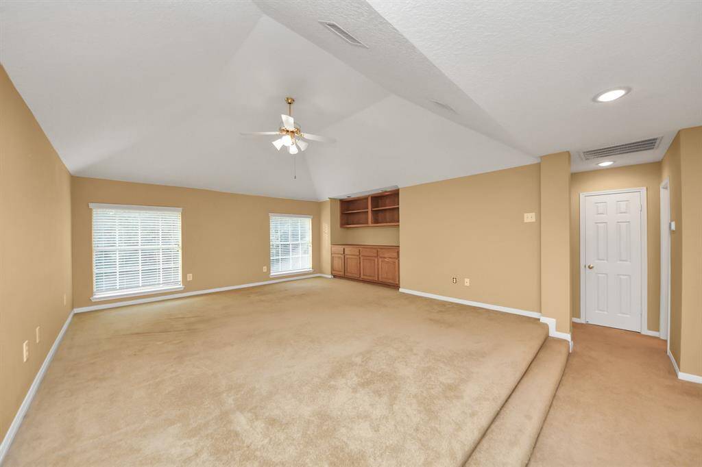 The raised game room has built-in storage and offers a view of the back yard overlooking the pool)