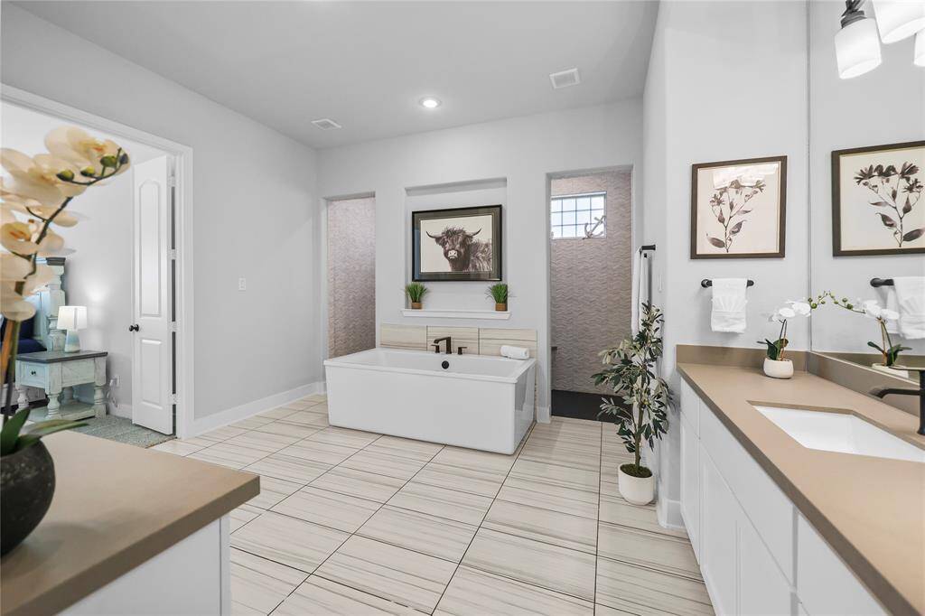 Every day will feel like a vacation in your resort-style bathroom. It's time to pack your bags! Let's head back toward the front of the home...