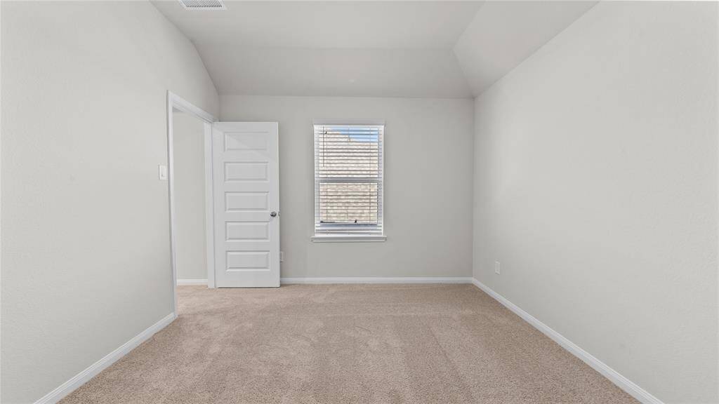 Bright and cozy second-floor bedroom with plush carpeting and ample natural light.