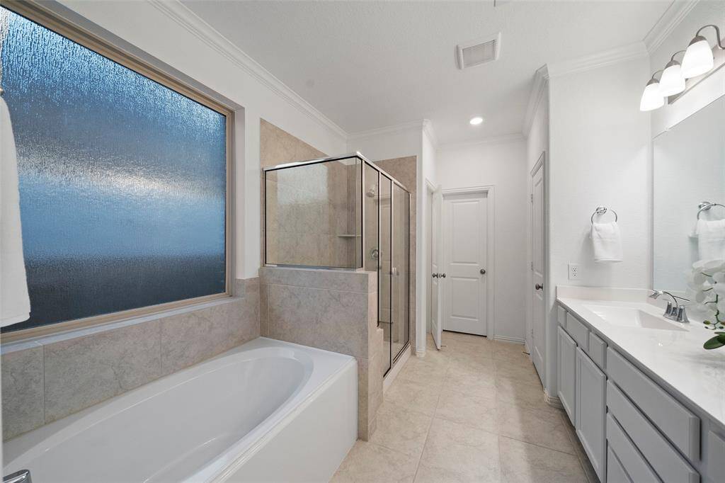 Tile Surrounds in the Primary Bath with a separate Shower for a spa-like experience! And Privacy Glass that lets natural light in.