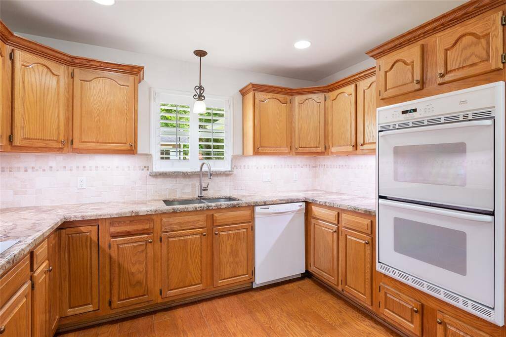 Granite counters, tumbled marble backsplash, large undermount stainless sink.