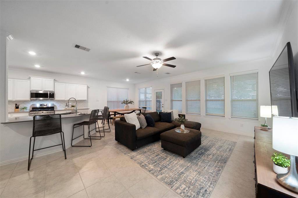 This open concept space beautifully integrates the kitchen, dining, and living areas!
