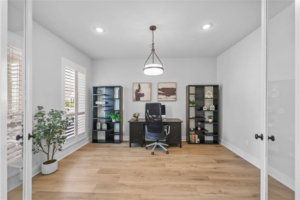 The dedicated home office sits through the glass front French doors just off the entrance. With a great view of the front-yard, this spacious room will set the stage for creativity and productivity.