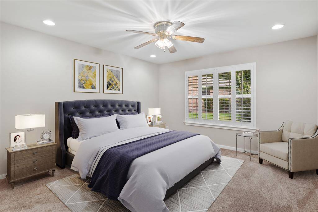 Primary bedroom virtually staged to show its generous size.