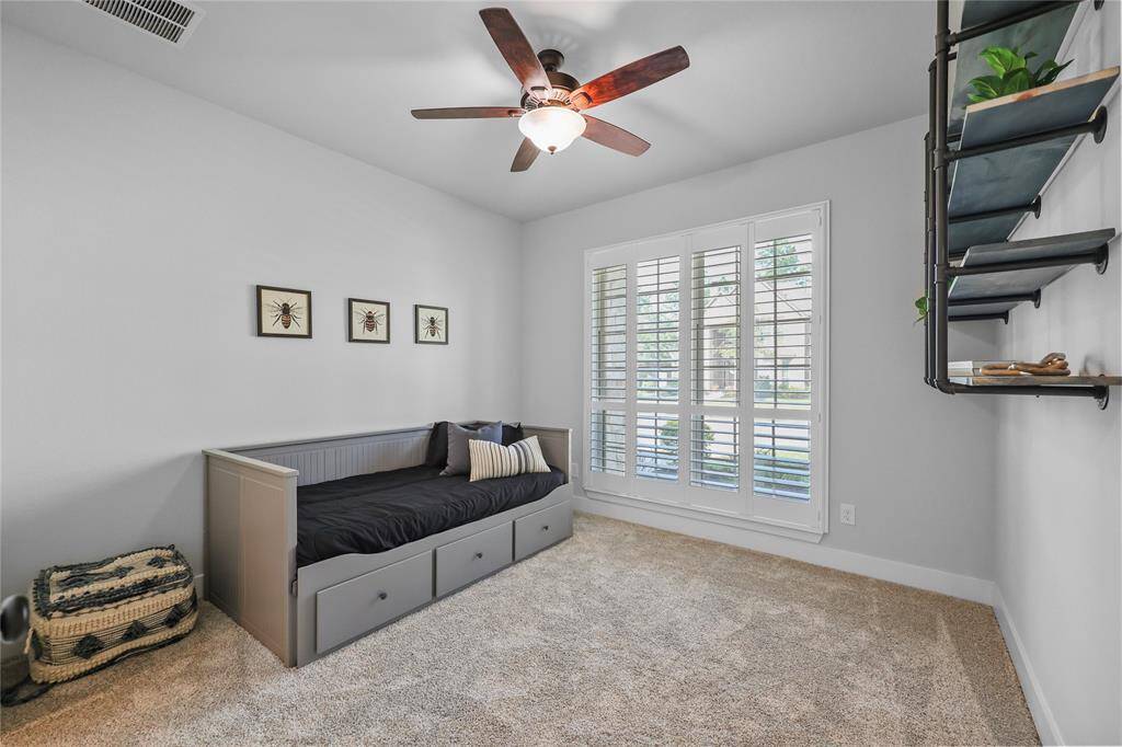 This downstairs secondary bedroom has an ensuite bathroom and a front-yard view. You'll notice that all of the main windows have plantation shutters! This room is well suited for a guest bedroom or multi-generational living.