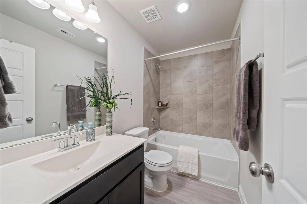 The secondary bathroom has plenty of space and upgraded tile shower.