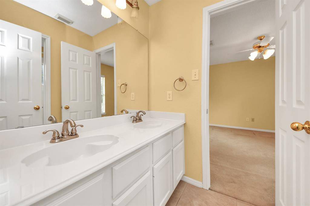 The upstairs bath features double sinks and plenty of storage