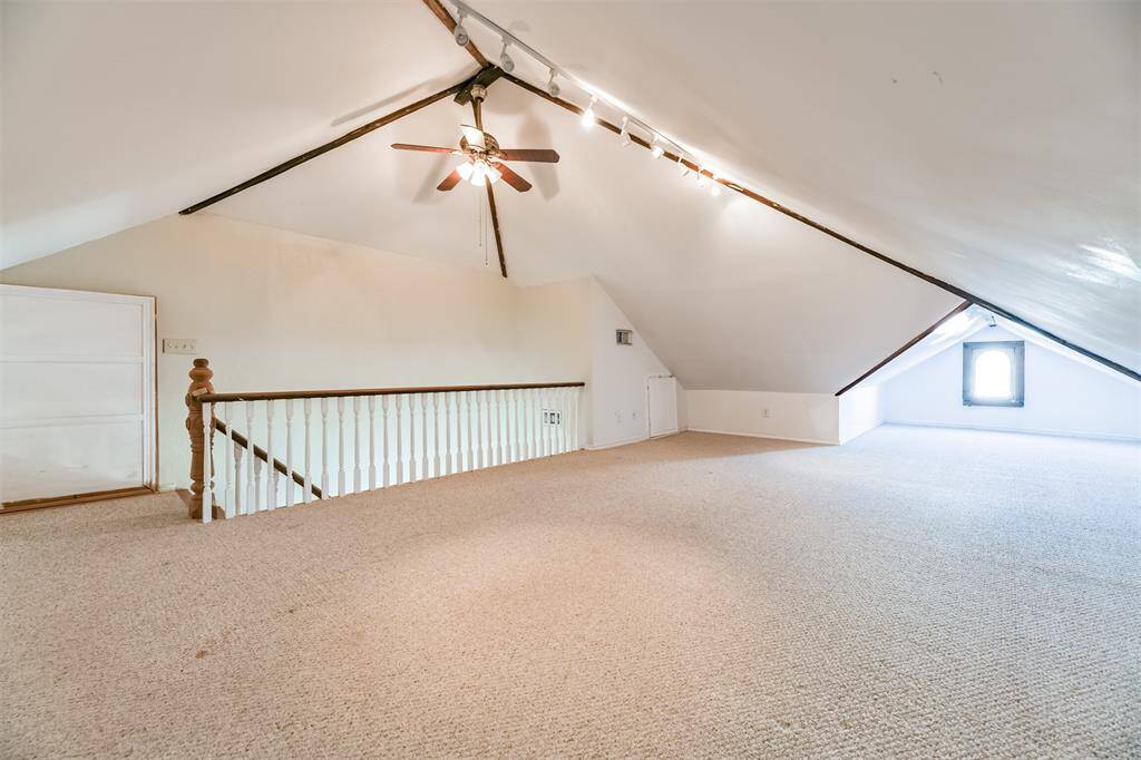 Secluded on the third floor, this air-conditioned multi-use space makes for a great game room or sleepover space! Here, you'll find a peaked ceiling with a lighted ceiling fan, track lighting, Berber carpet, original windows, and built-in storage along the outside walls,