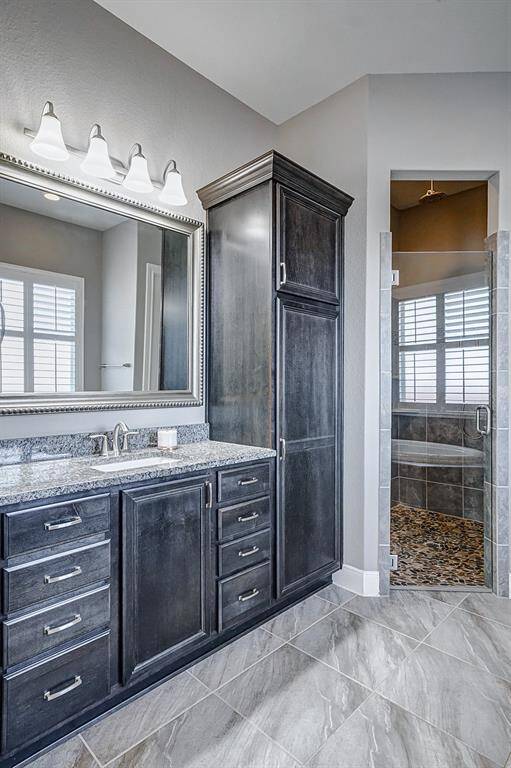 Primary Bath also includes two separate vanity areas and extra storage.