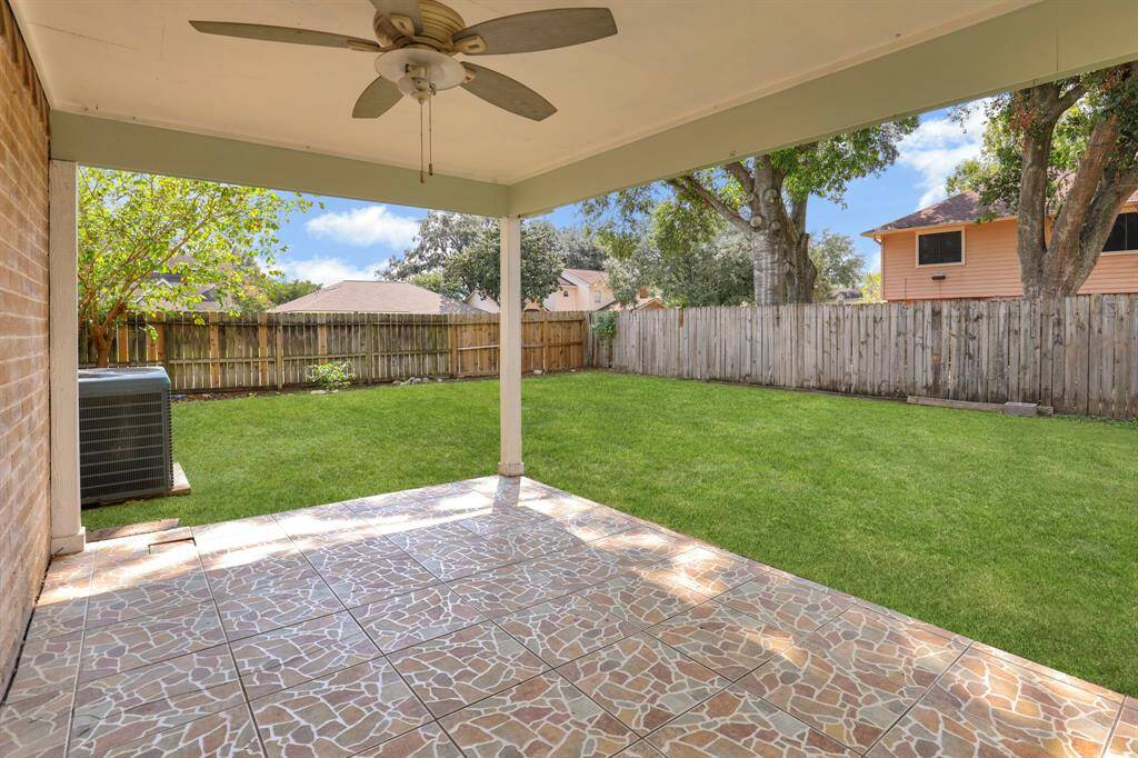 Covered patio with big backyard.