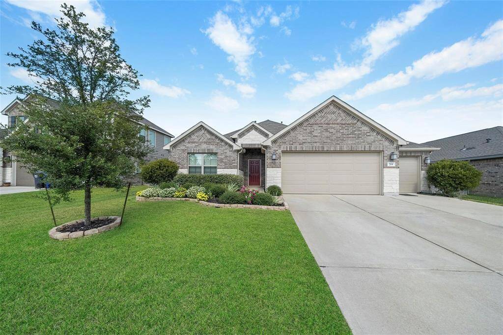 The landscaping on this listing is beautiful and a three car garage.