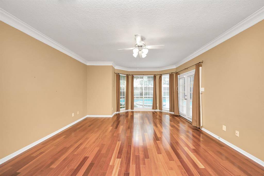 The bay windows in the Primary are floor-to-ceiling and give an great view of the pool. Notice the French door access to the back patio/pool area.