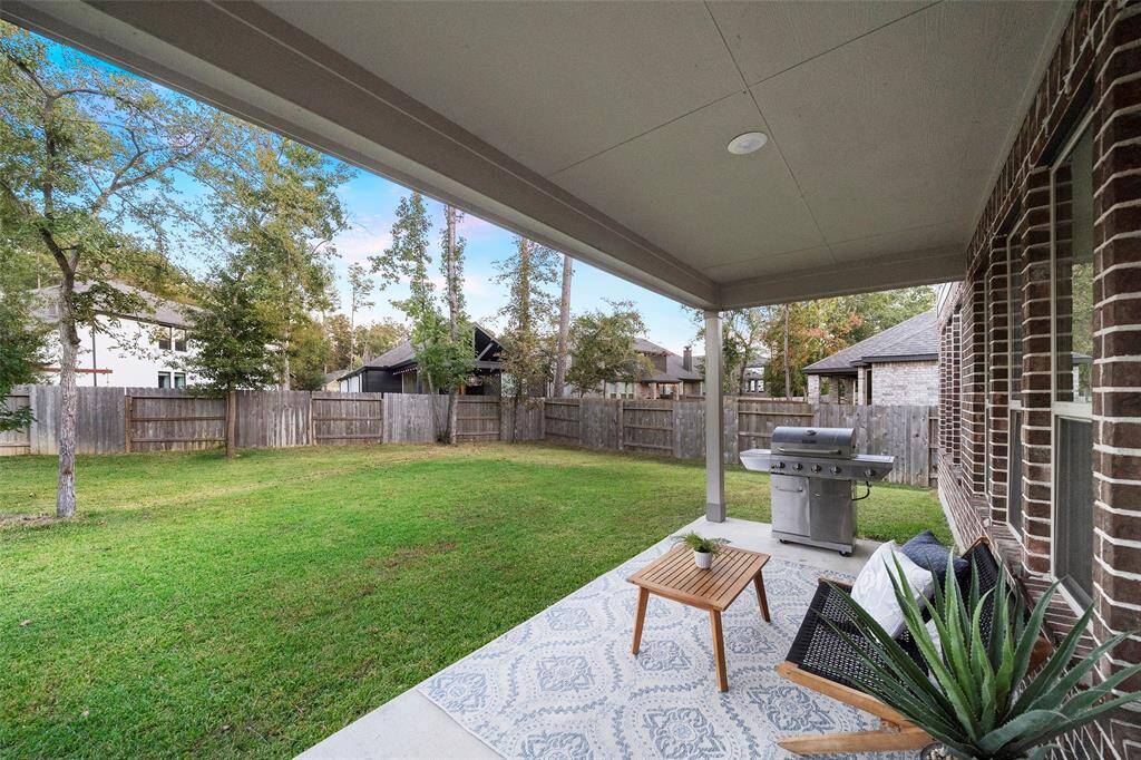 This cozy spot on the covered back patio is perfect for enjoying outdoors moments in any weather.