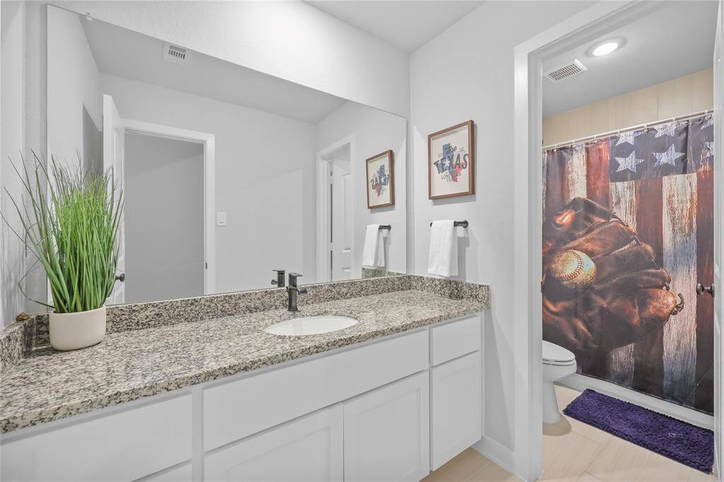 The upstairs full bath accessible from the hallway. The toilet/shower are divided from the sinking giving flexibility in use for morning routine!