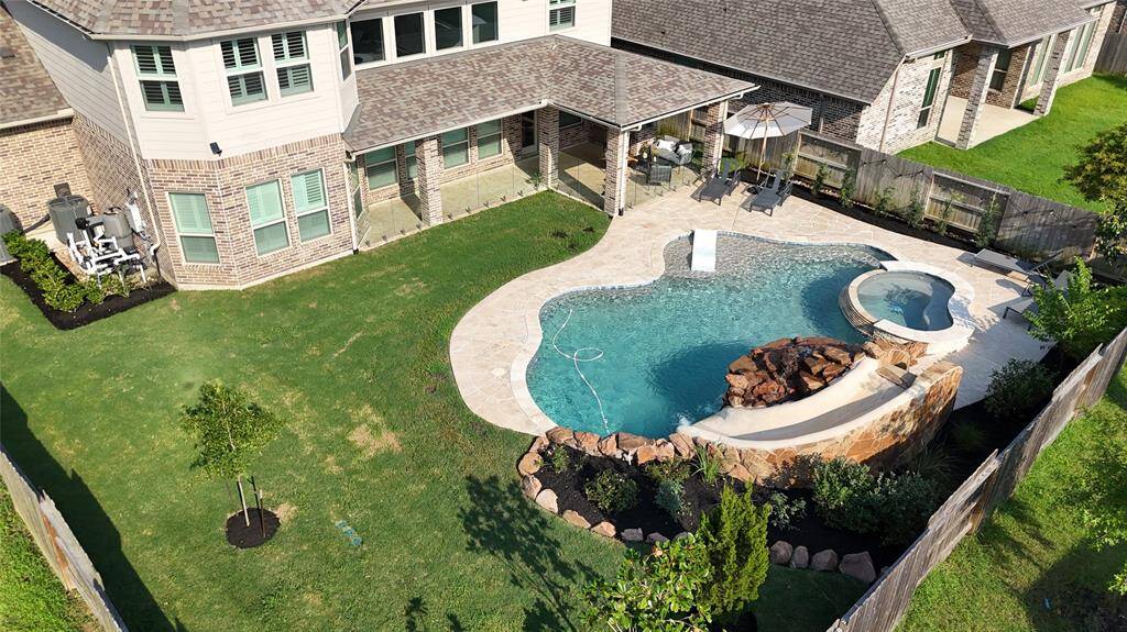 This birds eye view showcases the gorgeous resort pool in your future. It also highlights how much additional yard space is remaining for additional use & customization.