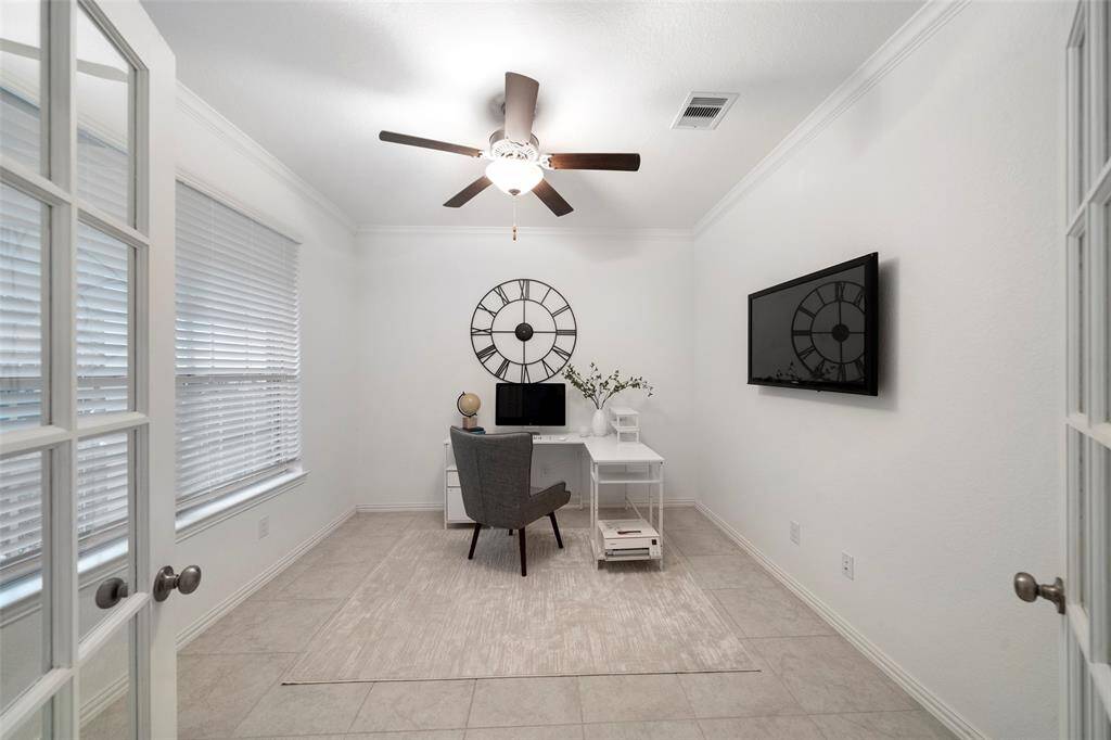 Elegant French doors open to a bright and welcoming home-office!