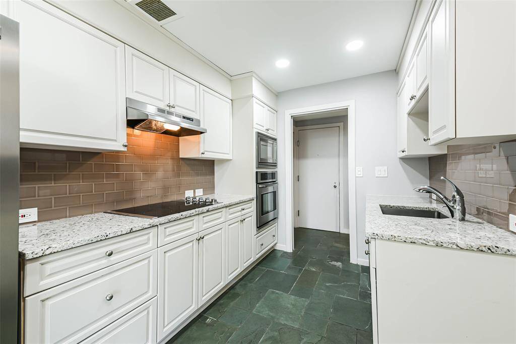 New cabinetry and subway tile backsplash in the kitchen.