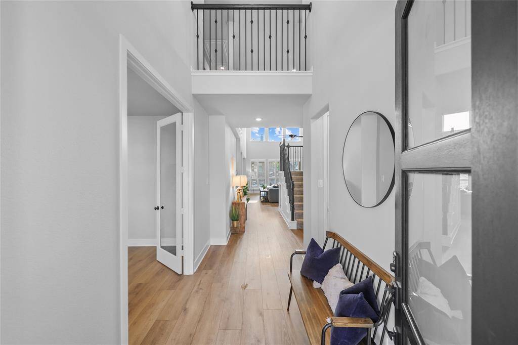 As you pass your extended bricked front porch you'll enter the home and be immediately greeted by a grand 2 story entrance and a view straight to the backyard! (Your dedicated home office sits to the left of the foyer and your private secondary bedroom is accessible to your right.) Let's skip to your main living area first!