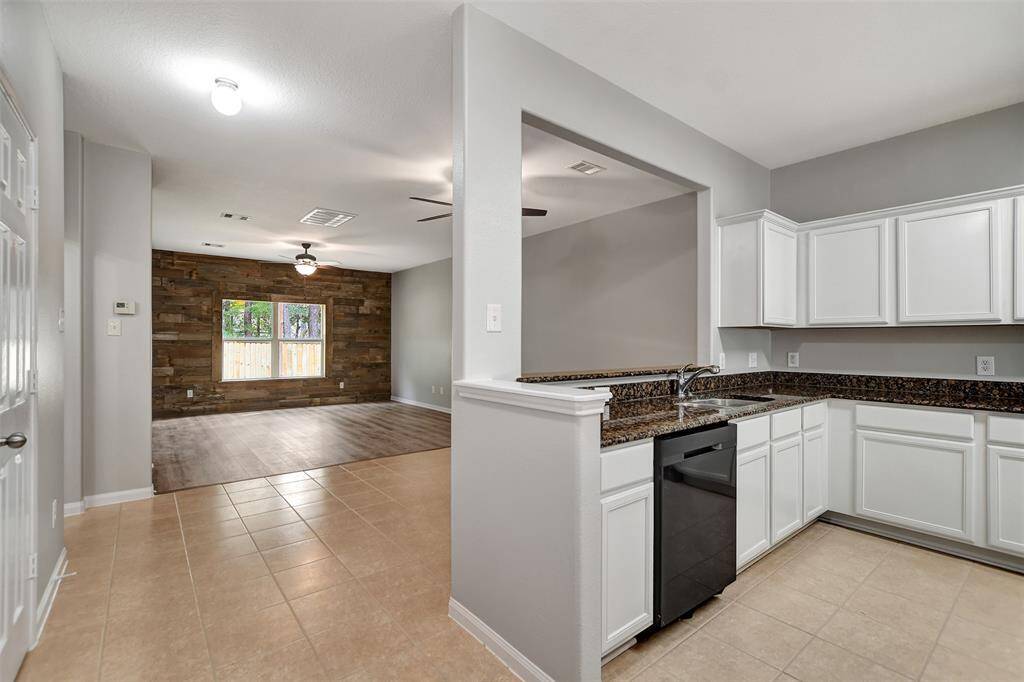 Standing at the front door and view towards kitchen and den