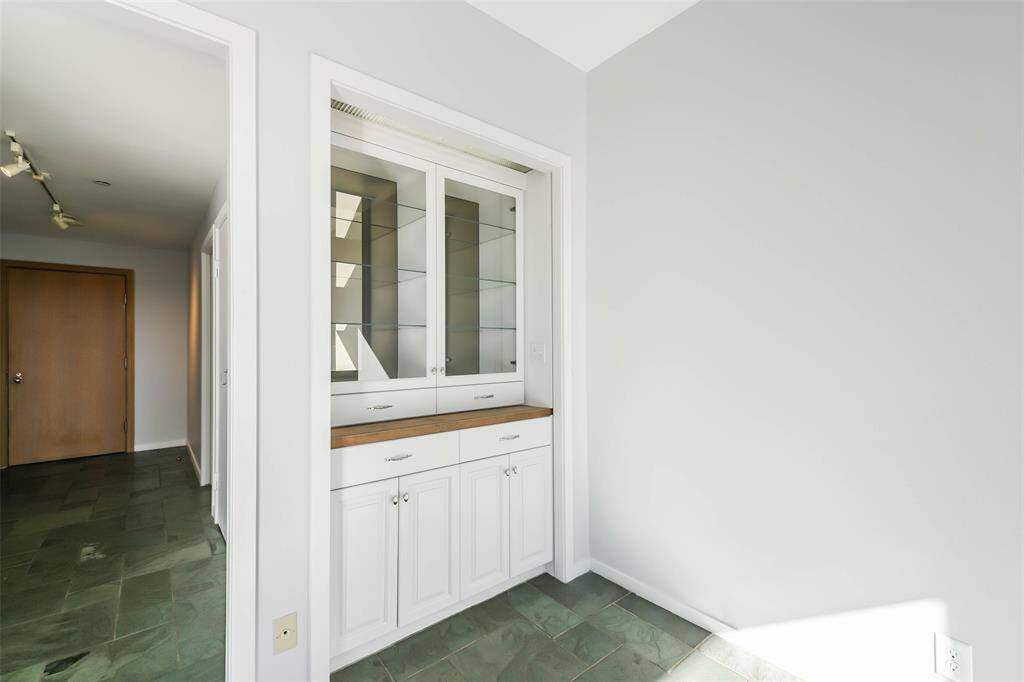 Additional cabinet in the living area allows for storage as well as displaying books, collectibles and decorative items.