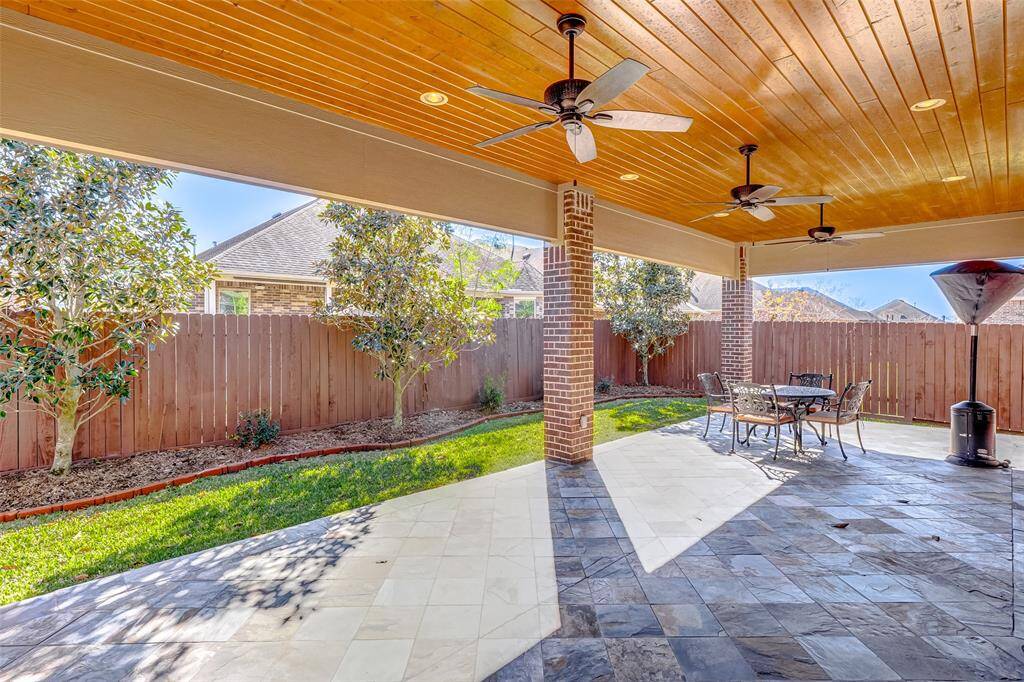 The large back patio is 450 sq ft.  with slate floors and a tongue and groove ceiling.