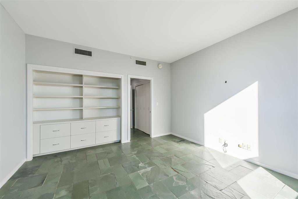 Sizeable secondary bedroom offers built-ins for storage and functionality.