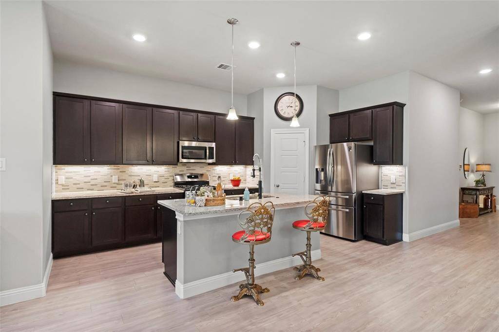 The kitchen boasts plenty of cabinets and led lighting.
