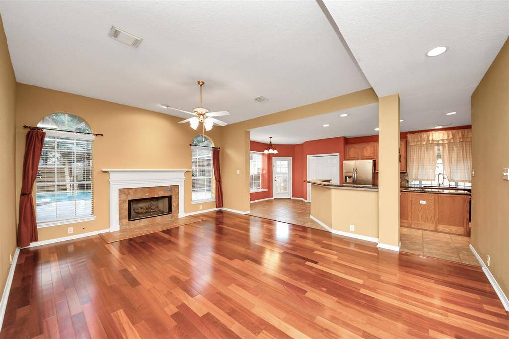 A view of just how open this floor plan is with easy kitchen access, breakfast room and a hosts of windows that allow natural light in.