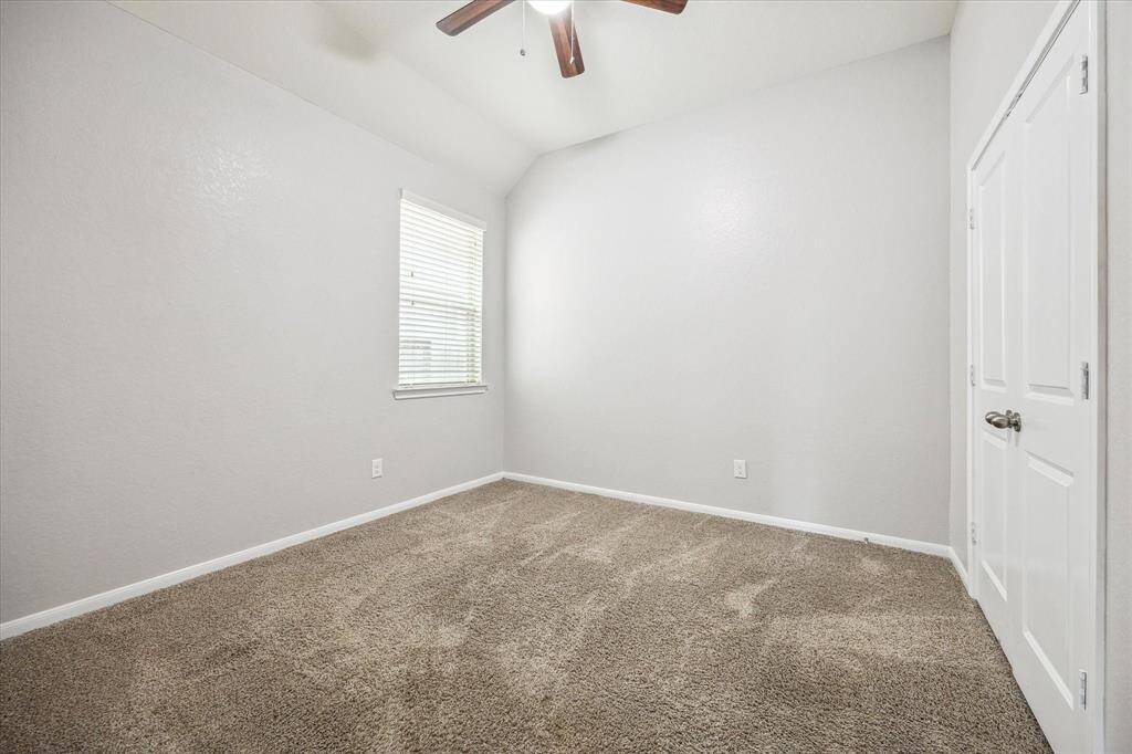 Downstairs is another bedroom with vaulted ceiling and lighted fan.