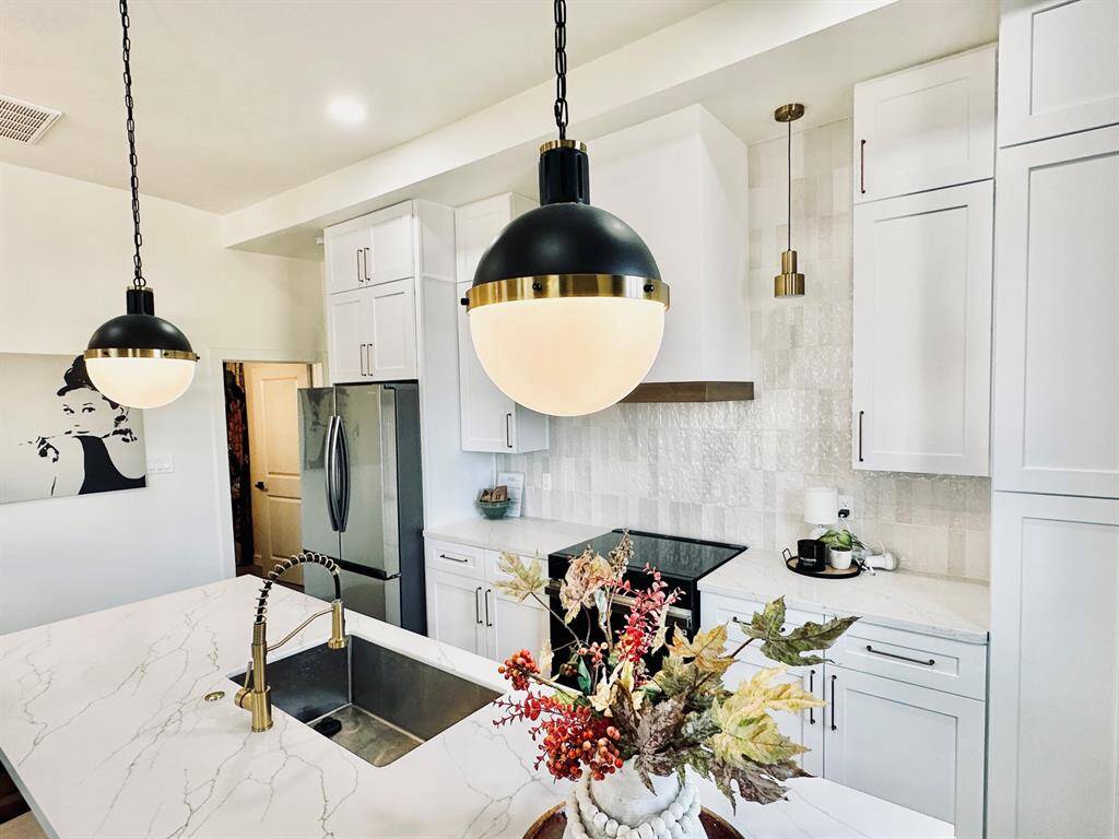 Gorgeous lighting and all new cabinets and countertops.
